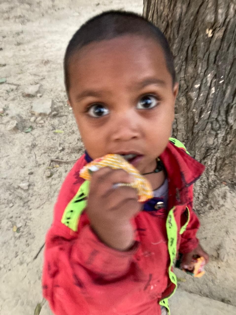 Close-up portrait of a young child supported by Ayushman Foundation